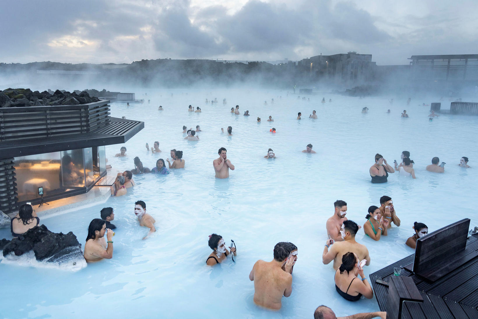 Image of the Blue Lagoon, Iceland, with diverse visitors.